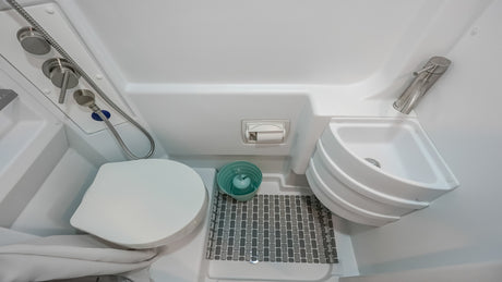This rv rental wet bath features a space-saving toilet, corner sink, and shower for your travels.