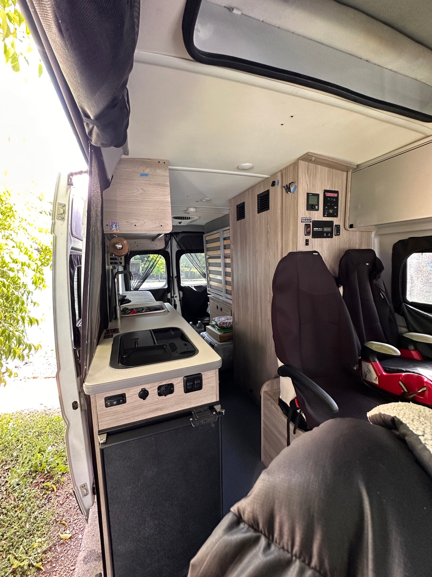 Inside an **rv rental**: functional kitchenette, control panels, and comfortable seating for your next road trip adventure.