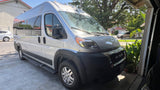 Bright white Ram ProMaster van, perfect for RV rental, is parked in a sunny residential driveway.