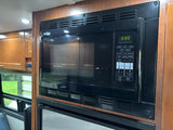 Black High Pointe microwave in an rv rental kitchen, its digital display shows '88:88' and features various cooking options.