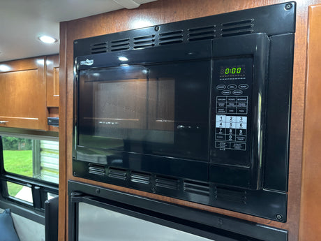 Black High Pointe microwave in an rv rental kitchen, its digital display shows '88:88' and features various cooking options.