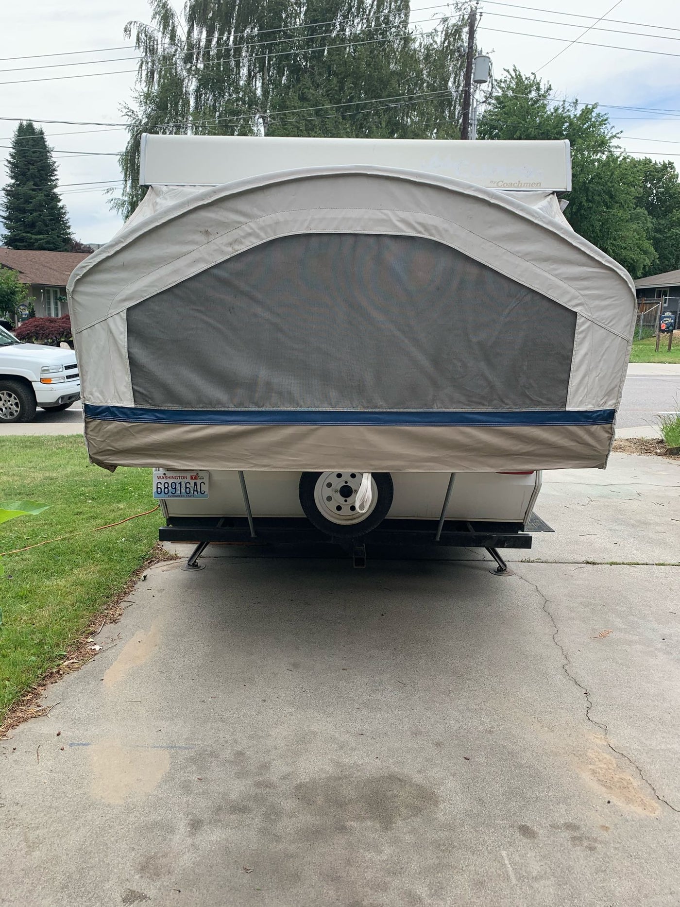 Rear view of an extended pop-up camper RV rental, showing its large screen window. Washington plate. — photo 6