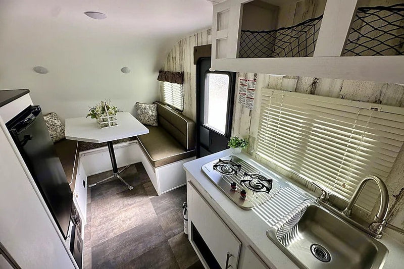  and ample cabinet storage.|RV rental compact wet bath — photo 13