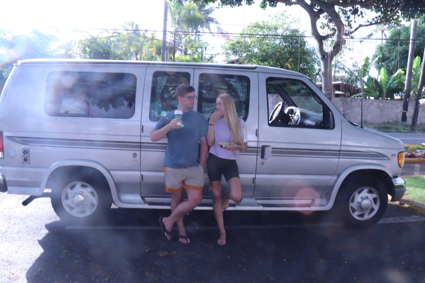 A happy couple stands by their silver RV rental van, enjoying a break. Perfect for travel and adventure. — photo 11