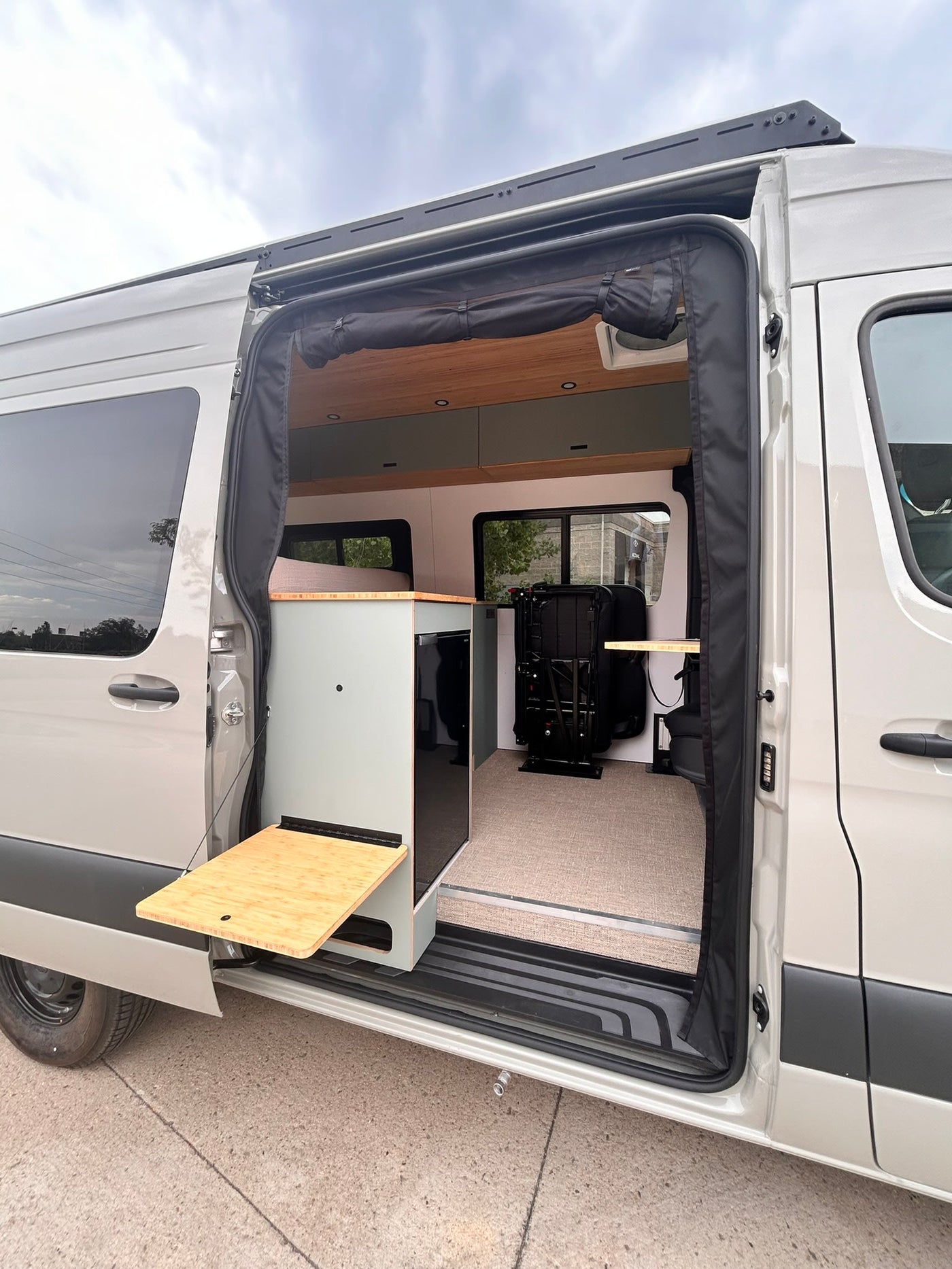  and intelligent storage solutions.|Cozy RV rental interior with a comfortable bed — photo 9