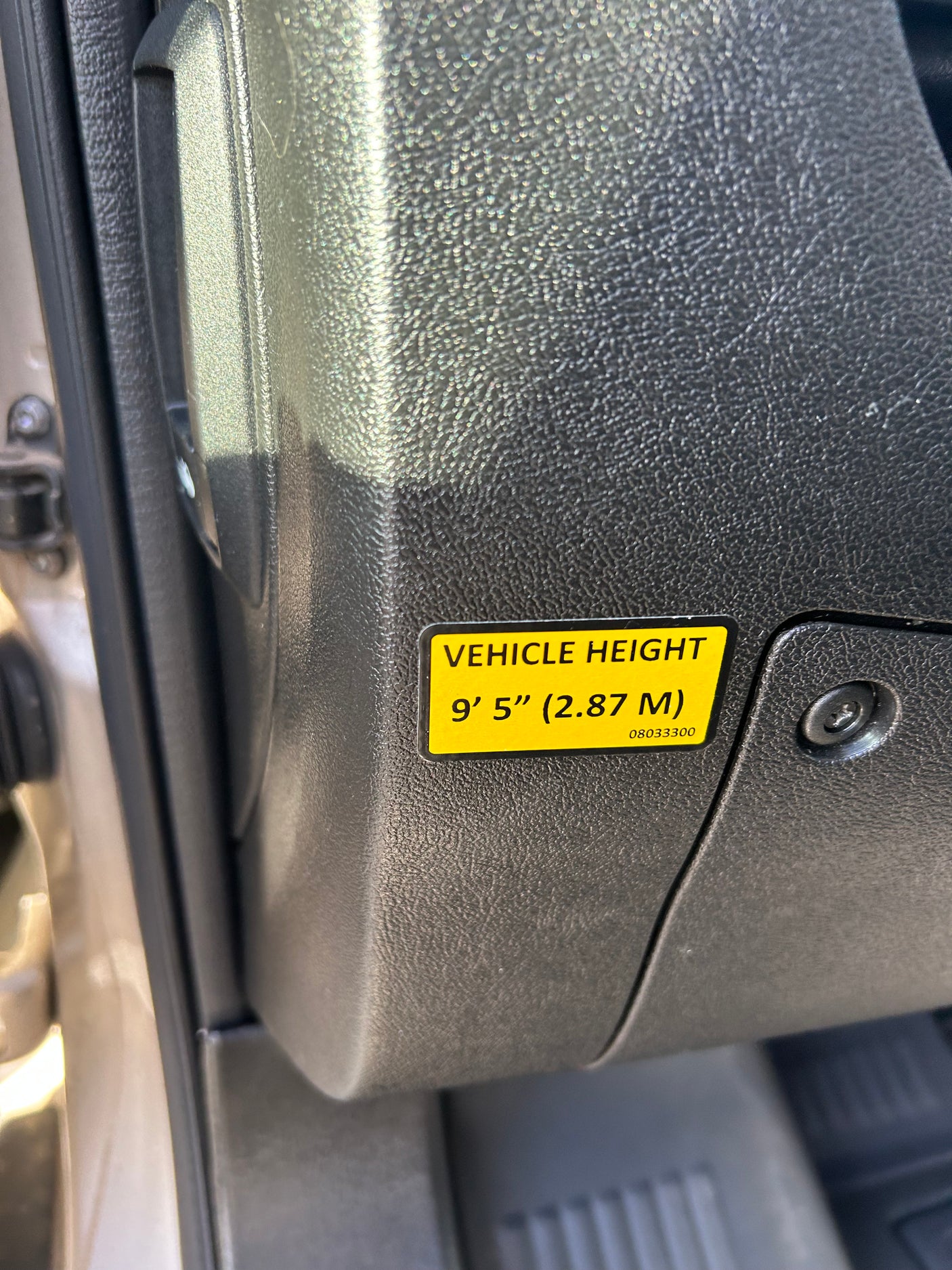 Yellow 'VEHICLE HEIGHT' sticker in an RV rental: 9' 5" (2.87 M), vital for clearances.