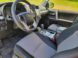 Interior view of a modern SUV's driver side, showing the steering wheel, dashboard, shifter, and fabric seats. Great for an rv rental adventure.