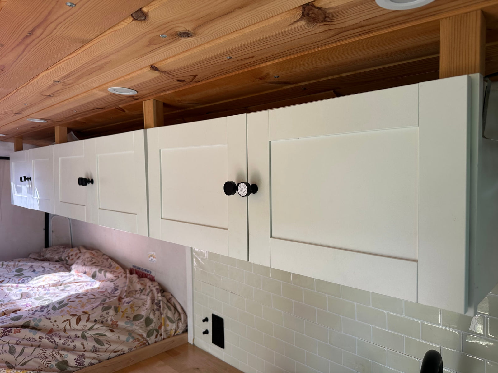  perfect for dining or a mobile office space.|Cozy RV rental interior featuring light overhead cabinets