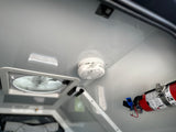 Essential RV rental safety: A smoke detector, fire extinguisher, and ceiling vent fan installed for occupant protection.