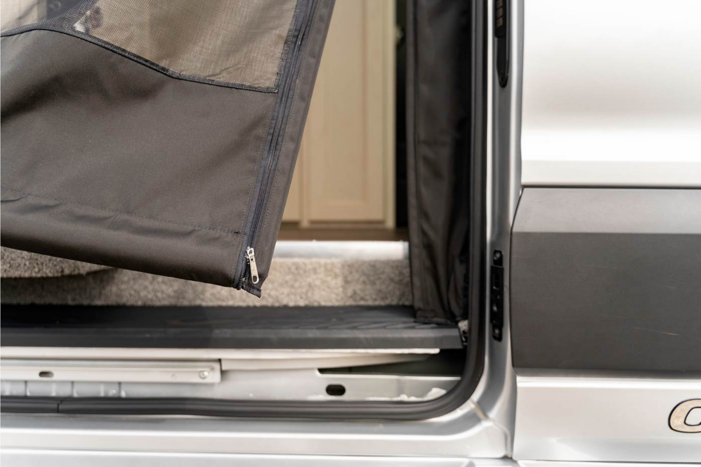 An RV rental's side entrance, featuring a durable black zippered mesh screen opening to the interior. — photo 14