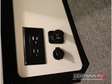 RV rental interior: AC wall outlet & 12V/USB charging ports for devices.