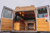 Experience outdoor fun! This RV rental camper van's cozy interior, with autumn decor, awaits your next camping trip.