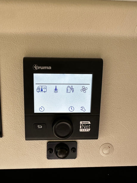 RV rental's Truma digital control panel, displaying climate (heating/fan) and system settings for clear camper operation.