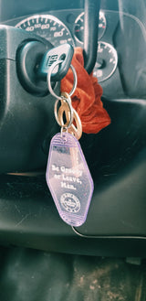 Road trip ready! Car key in ignition with a 'Be Groovy' keychain and peace sign. Perfect for an rv rental adventure.