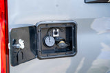 RV rental: Exterior utility compartment with non-pressure water fill, data port, and other hookups visible.