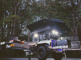 Equipped overland camping trailer: rooftop tent, pull-out kitchen, fridge. Ideal for your next RV rental adventure.