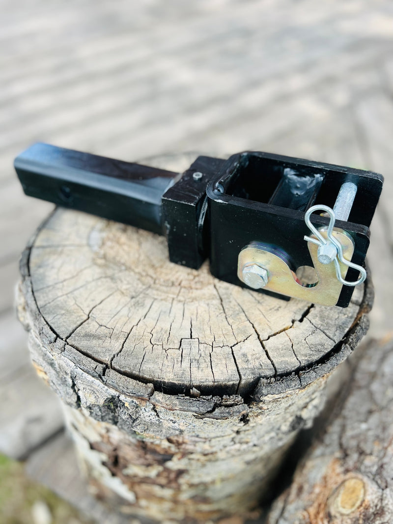Black tow hitch receiver with pin, on a wood stump. Ready for RV rental or trailer towing. — photo 20