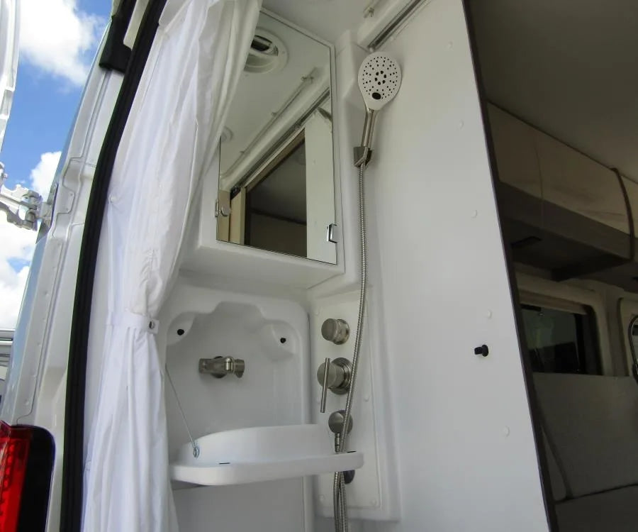 An RV rental's versatile outdoor shower with collapsible sink and mirror offers convenient mobile washing.
