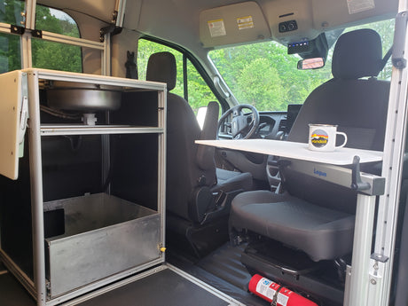 RV rental: Compact van conversion interior with a kitchen sink, versatile Lagun table, and front cabin area.