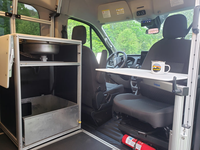 RV rental: Compact van conversion interior with a kitchen sink, versatile Lagun table, and front cabin area.
