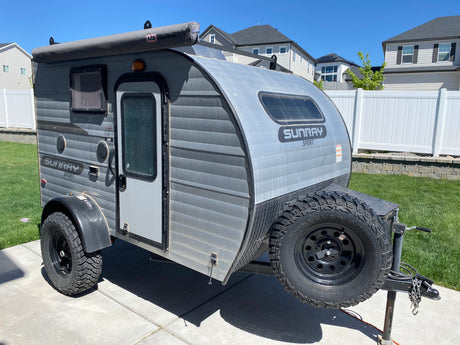 This rugged Sunray Sport off-road teardrop camper with an awning is ideal for an RV rental adventure.