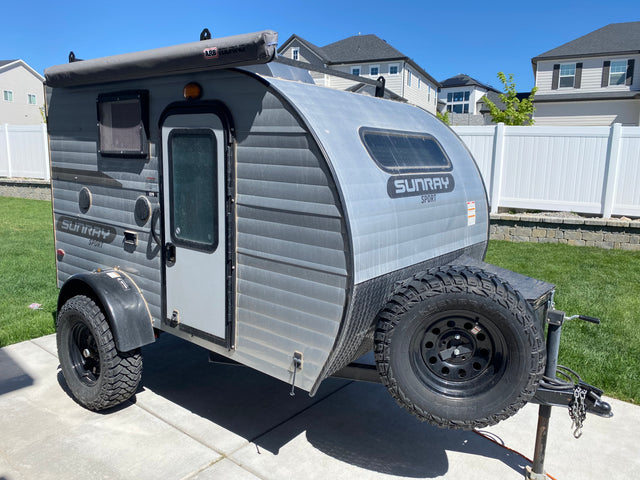 This rugged Sunray Sport off-road teardrop camper with an awning is ideal for an RV rental adventure.