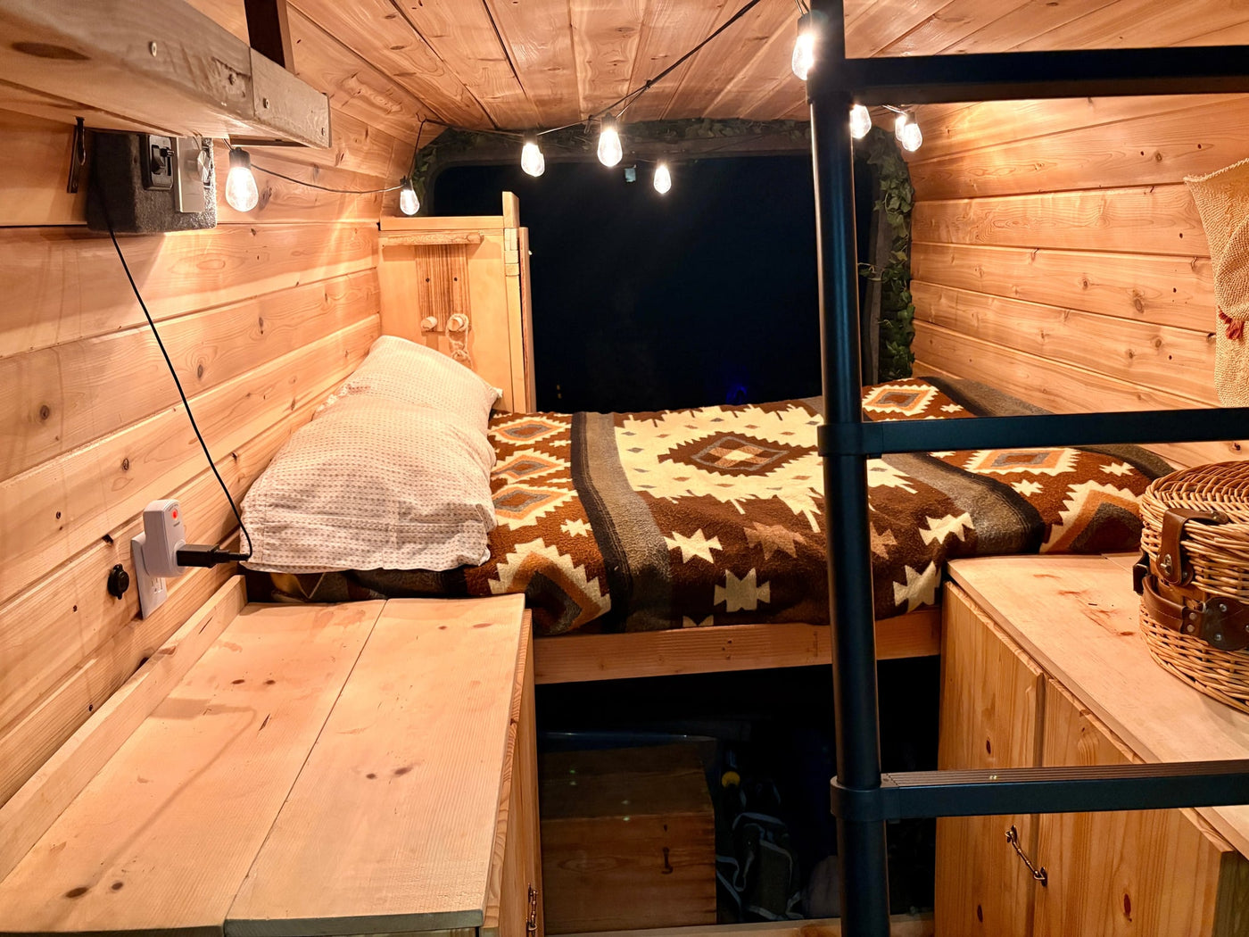  and a sunny view of trees in the side mirror.||Inside an rv rental: cozy van interior featuring fluffy seat covers — photo 10