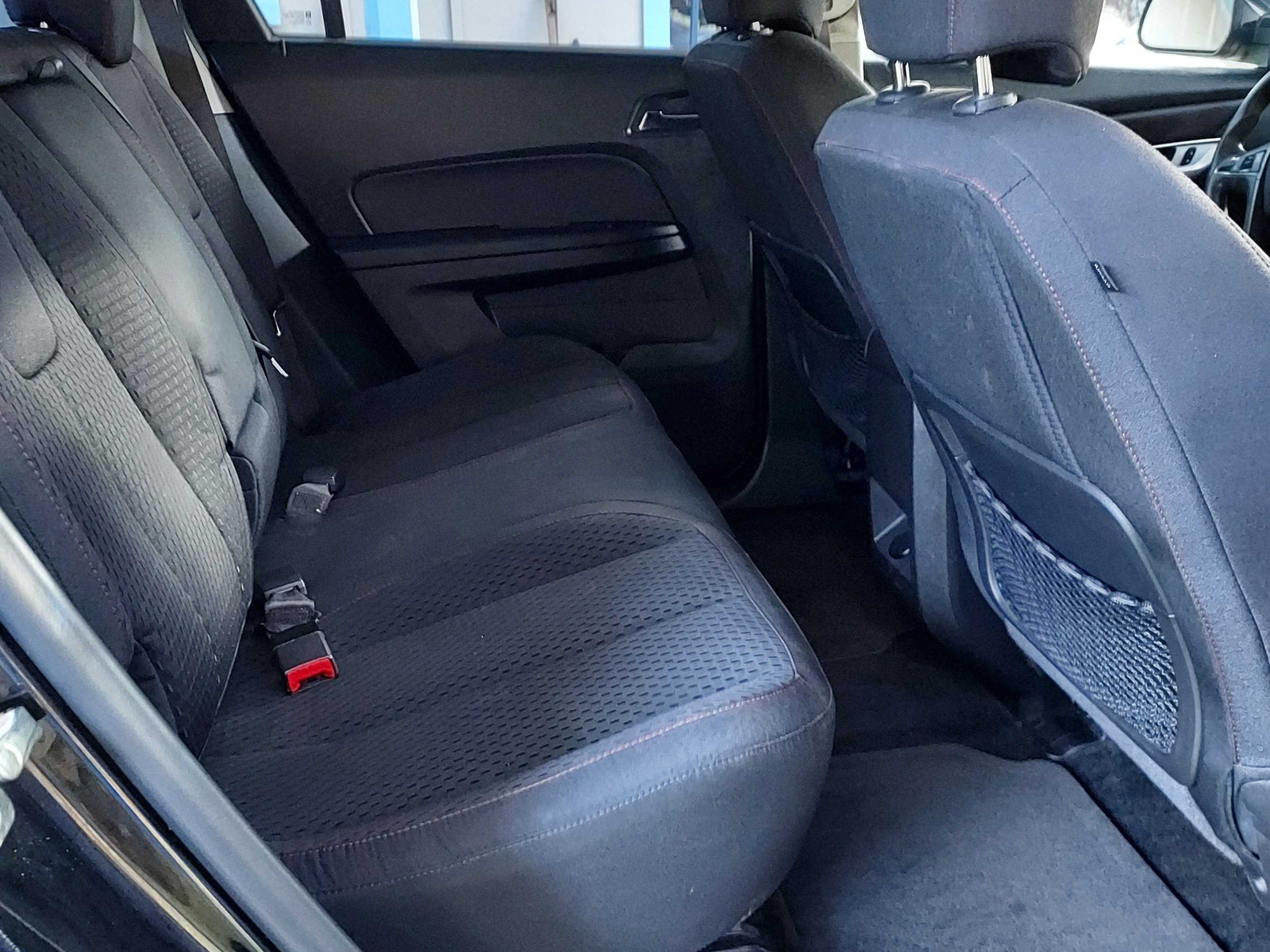 Rear vehicle interior featuring clean, comfortable back seats and seatbelts, ready for your RV rental road trip.