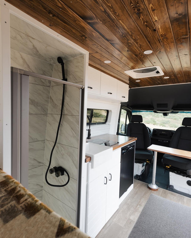  ideal for adventurers.|An RV rental camper van parked in a vast desert landscape with train tracks