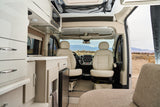 Bright rv rental interior featuring a modern kitchenette, comfortable swivel front seats, and scenic mountain views.