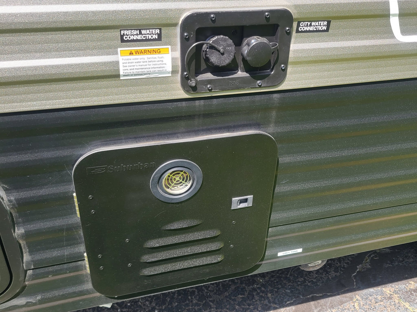  with a window view of green grass.|Compact RV rental bathroom: white toilet on a raised platform next to a shower stall.|Digital thermostat in an RV rental — photo 13
