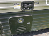  with a window view of green grass.|Compact RV rental bathroom: white toilet on a raised platform next to a shower stall.|Digital thermostat in an RV rental