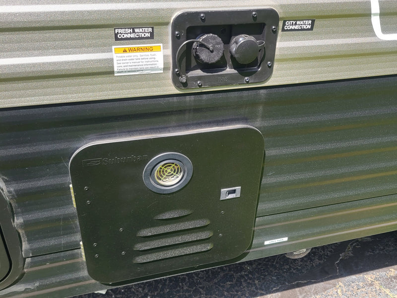  with a window view of green grass.|Compact RV rental bathroom: white toilet on a raised platform next to a shower stall.|Digital thermostat in an RV rental — photo 13