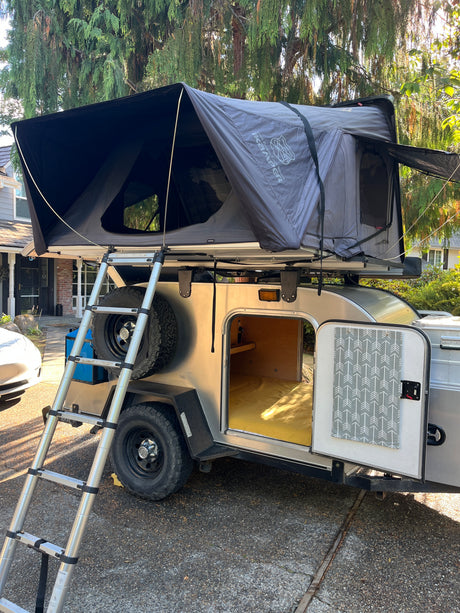 Explore the outdoors with this unique rv rental: a teardrop trailer featuring an iKamper rooftop tent. Ideal for camping!