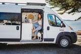 Woman & dog enjoying van life in a scenic RV rental.