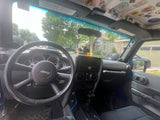 View inside a Jeep: dashboard, steering wheel, and dash-mounted ducks. Perfect for day trips on your RV rental adventure.