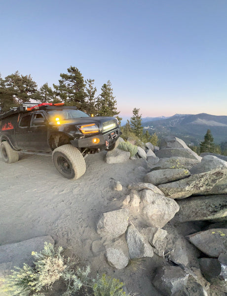 Rugged off-road truck on a mountain trail at dusk. Find adventure beyond a typical rv rental.