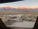 Waking up to golden hour mountains from an RV rental. Expansive desert view with beautiful natural light.