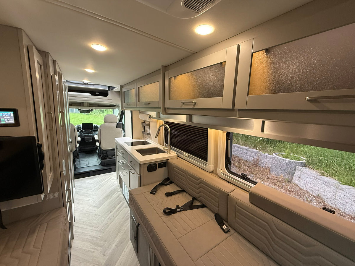  and convenient side storage.|Interior of an rv rental showing two long bench seats/beds — photo 6
