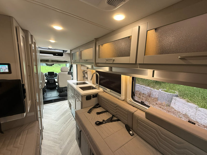  and convenient side storage.|Interior of an rv rental showing two long bench seats/beds — photo 6