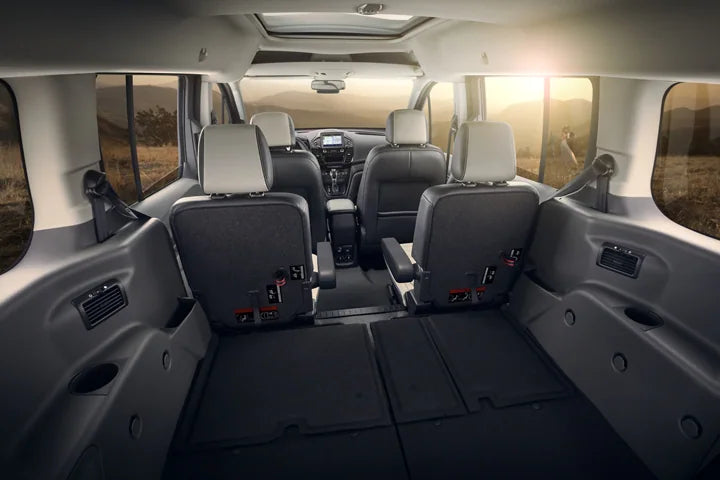  transparent body showing spacious multi-row seating. Ideal for an RV rental trip or large group transport.|Versatile RV rental interior: rear seats folded flat — photo 10