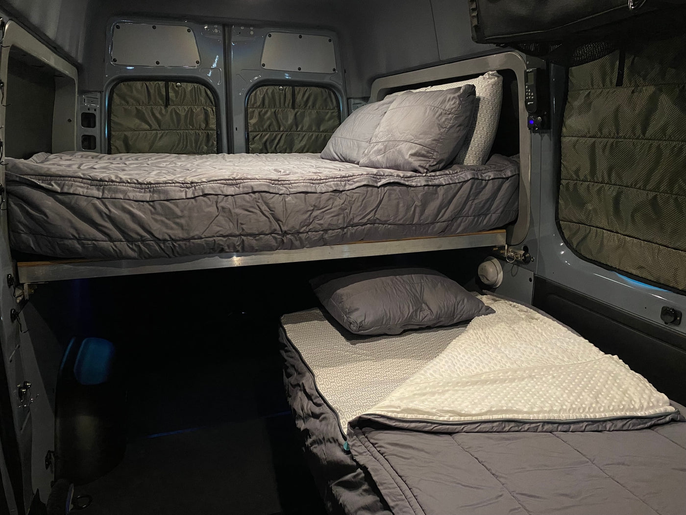 Inside a spacious RV rental: cozy bunk beds with comfy bedding, perfect for mobile adventures. — photo 13