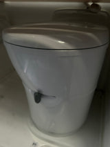 This RV rental features a compact white portable toilet, ideal for camping and on-the-go sanitation.