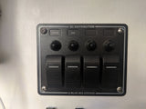 DC distribution control panel for RV rental, featuring switches for lights, fan & more. Power management.