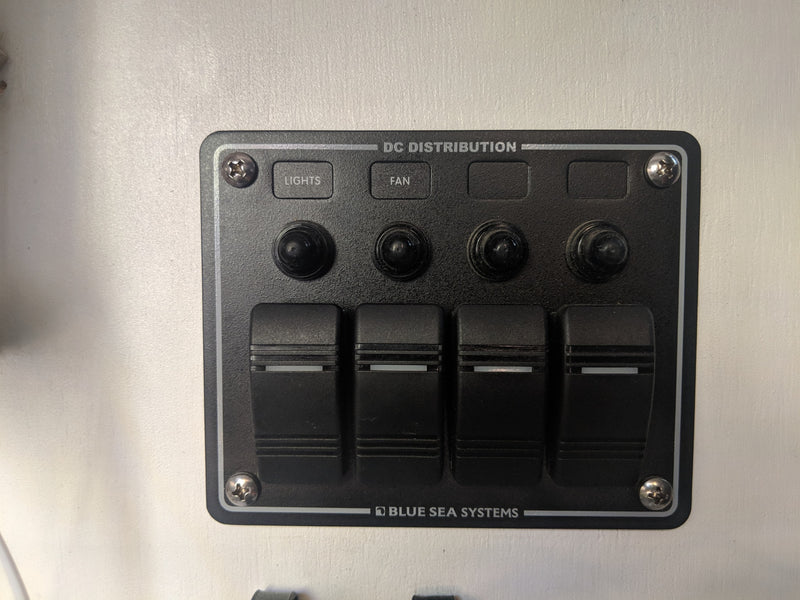 DC distribution control panel for RV rental, featuring switches for lights, fan & more. Power management. — photo 17