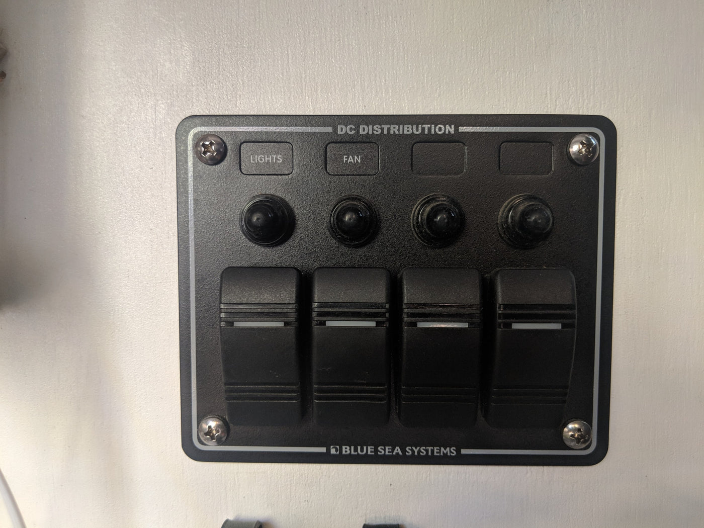 DC distribution control panel for RV rental, featuring switches for lights, fan & more. Power management. — photo 37