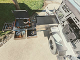 RV rental with a full-featured outdoor kitchen: stove, griddle, sink, organized utensils, and Rotopax water.