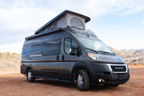 Dark gray Ram Tellaro camper van with pop-top roof for rv rental, parked outdoors.