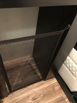 RV rental interior: View of a mesh storage net hanging via hooks from an overhead surface, for handy organization.
