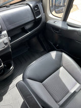 Ram Promaster RV rental interior: passenger dashboard, seat, and patterned rubber floor mat.